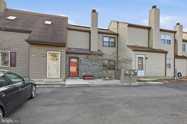 a front view of a house with basket ball court and garage