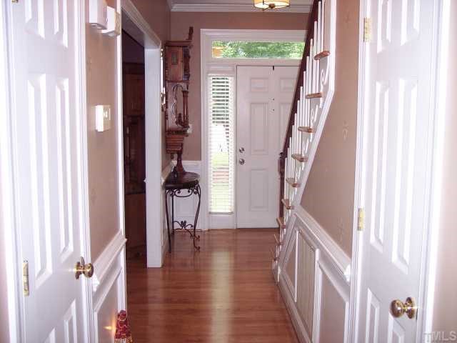 5824 Ventry Court Raleigh, NC 27613 - Photo 2 of 12 a view of a hallway with a wooden floor and entryway