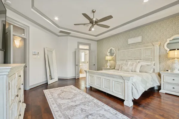 a bedroom with a large bed and a chandelier