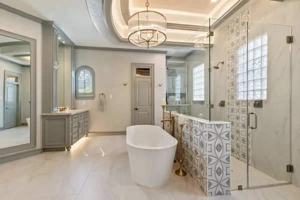 a spacious bathroom with a toilet a sink and mirror