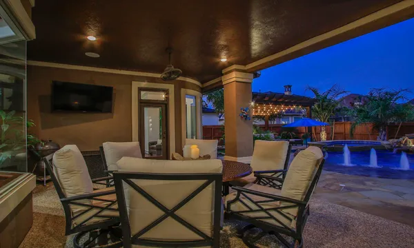 a backyard of a house with table and chairs
