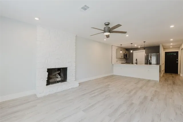 a view of a kitchen with a sink and a fireplace