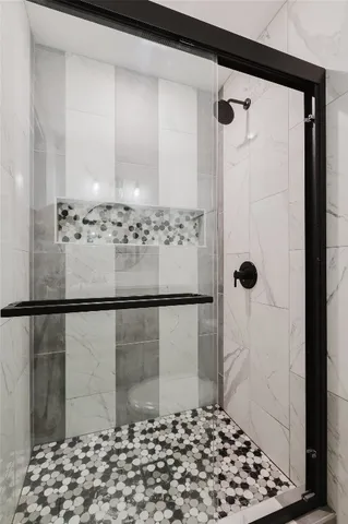 a bathroom with a shower and a shower