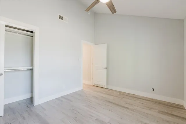 an empty room with wooden floor and closet
