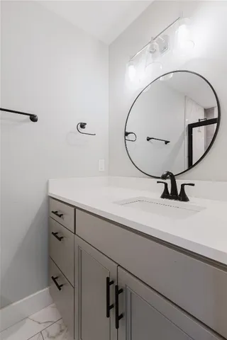 a bathroom with a sink mirror and vanity