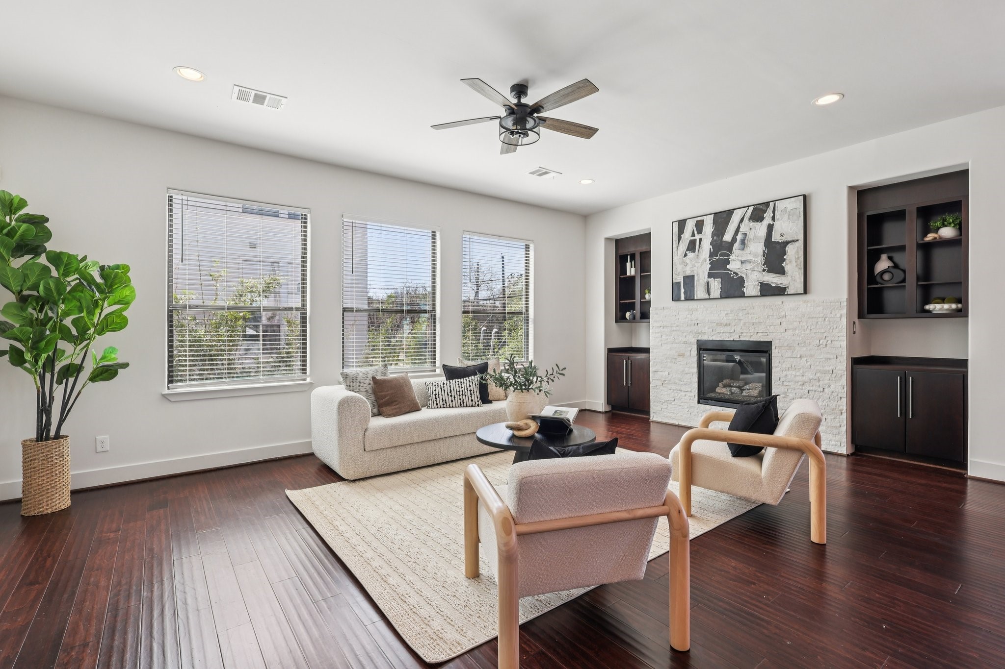 1771 Michigan Street Houston, TX 77006 - Photo 13 of 28 Enjoy this spacious living room with an abundance of natural light, an electric fireplace, and custom built in cabinetry.