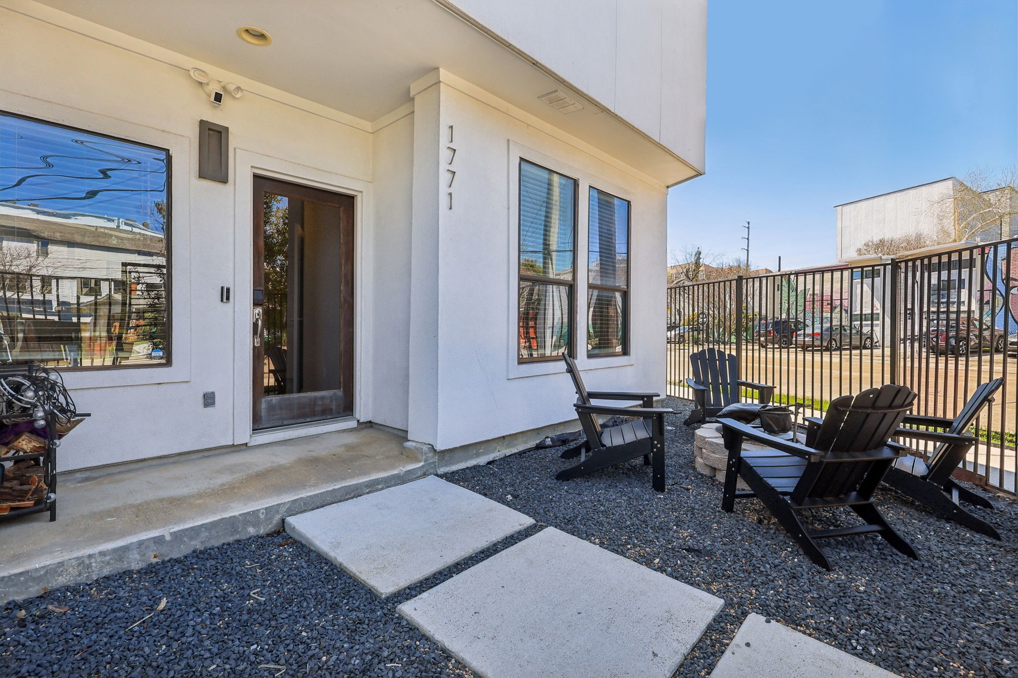 1771 Michigan Street Houston, TX 77006 - Photo 2 of 28 Private gated entrance set up with a fire pit and seating.