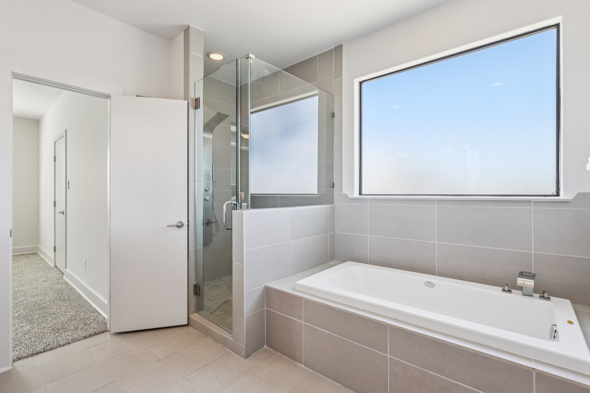 1771 Michigan Street Houston, TX 77006 - Photo 21 of 28 Large windows, a soaking tub, and a separate shower offer a spa-like experience.