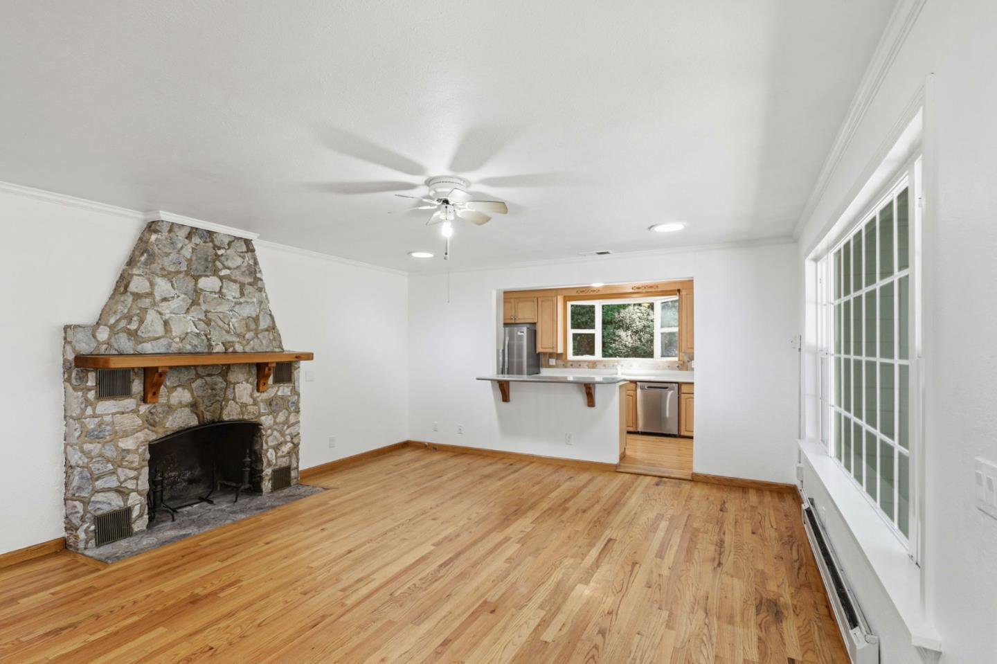 17760 China Grade Road Boulder Creek, CA 95006 - Photo 19 of 45 a view of an empty room with wooden floor fireplace and a window
