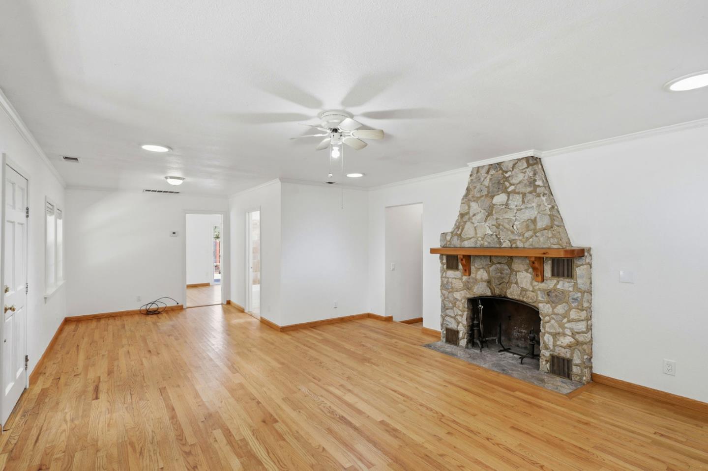 17760 China Grade Road Boulder Creek, CA 95006 - Photo 21 of 45 a view of empty room with wooden floor and fireplace
