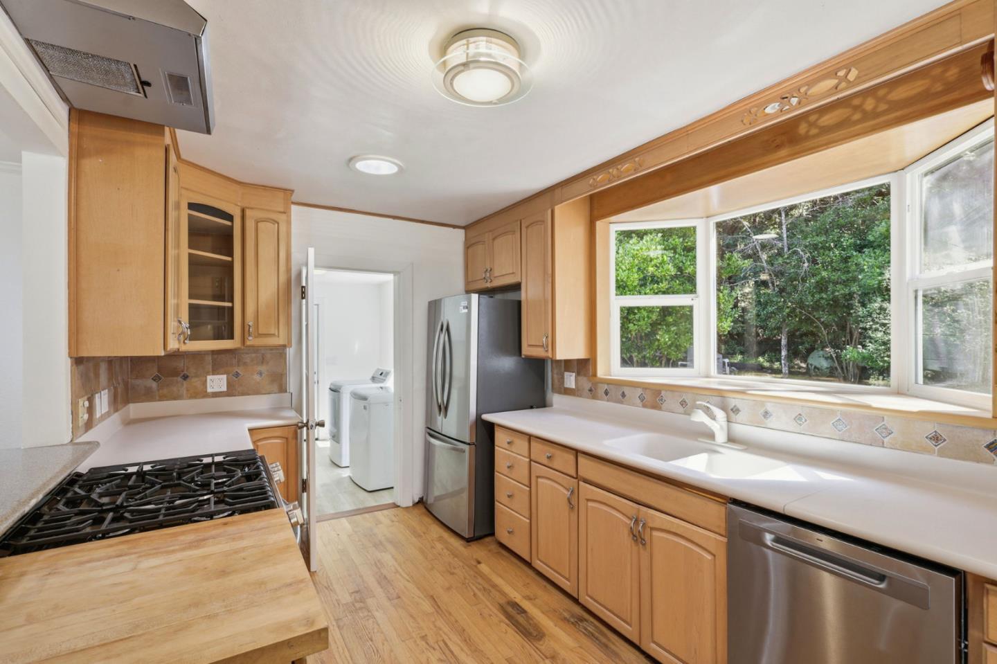 17760 China Grade Road Boulder Creek, CA 95006 - Photo 22 of 45 a kitchen with stainless steel appliances granite countertop a sink stove and refrigerator