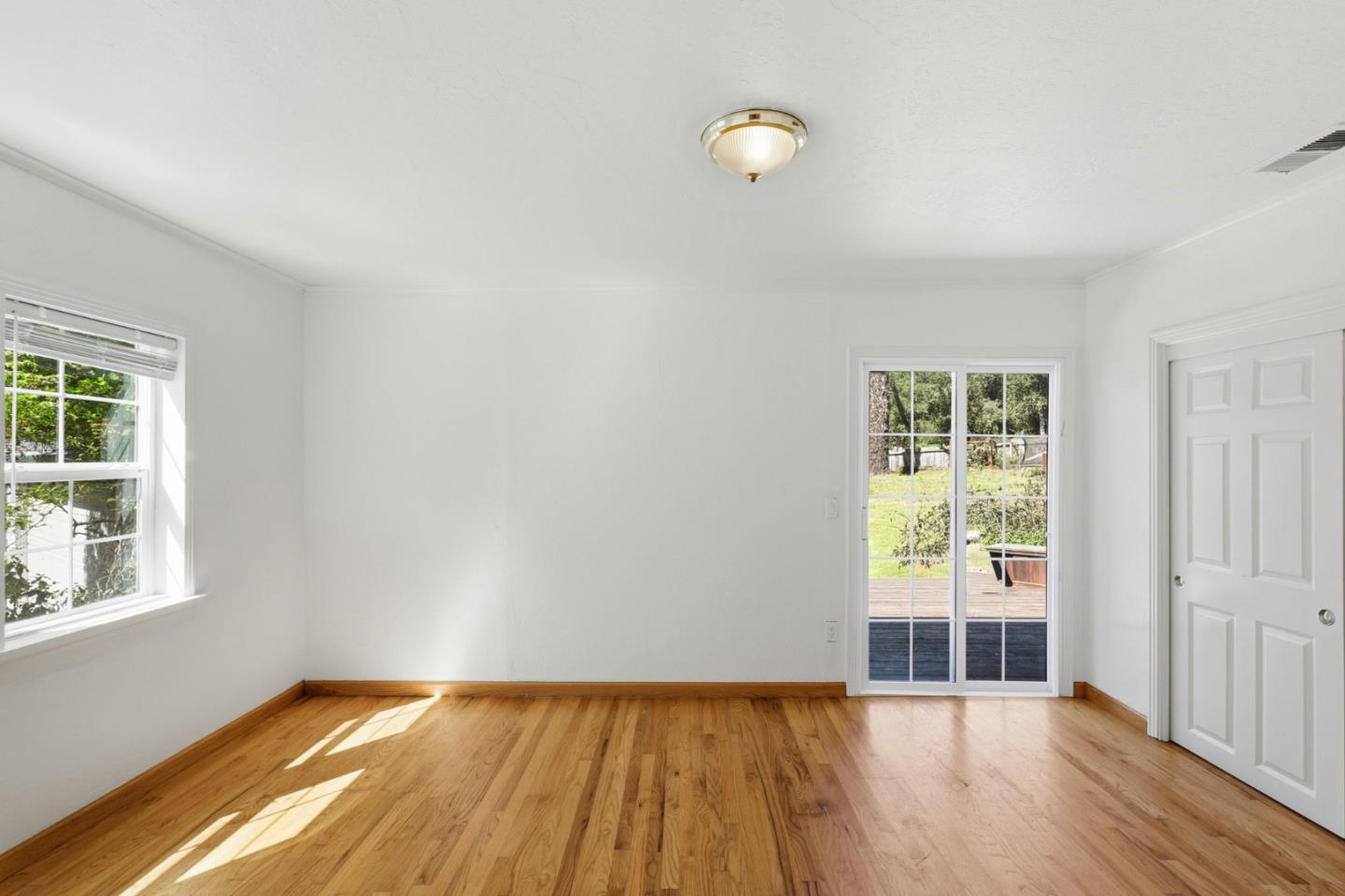 17760 China Grade Road Boulder Creek, CA 95006 - Photo 31 of 45 a view of an empty room with wooden floor and a window
