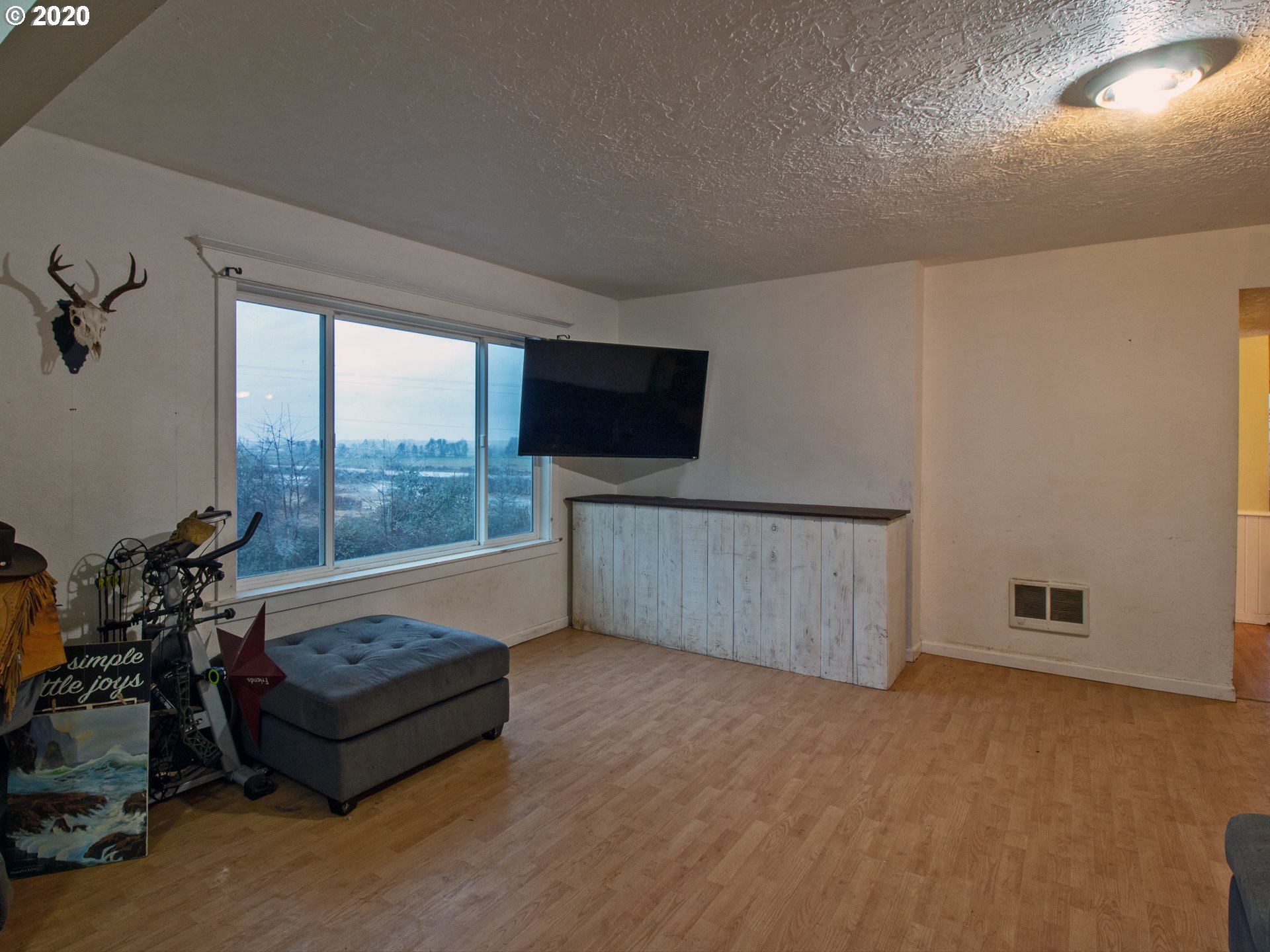 18711 Beaver Falls Road Clatskanie, OR 97016 - Photo 5 of 14 a living room with furniture and a flat screen tv