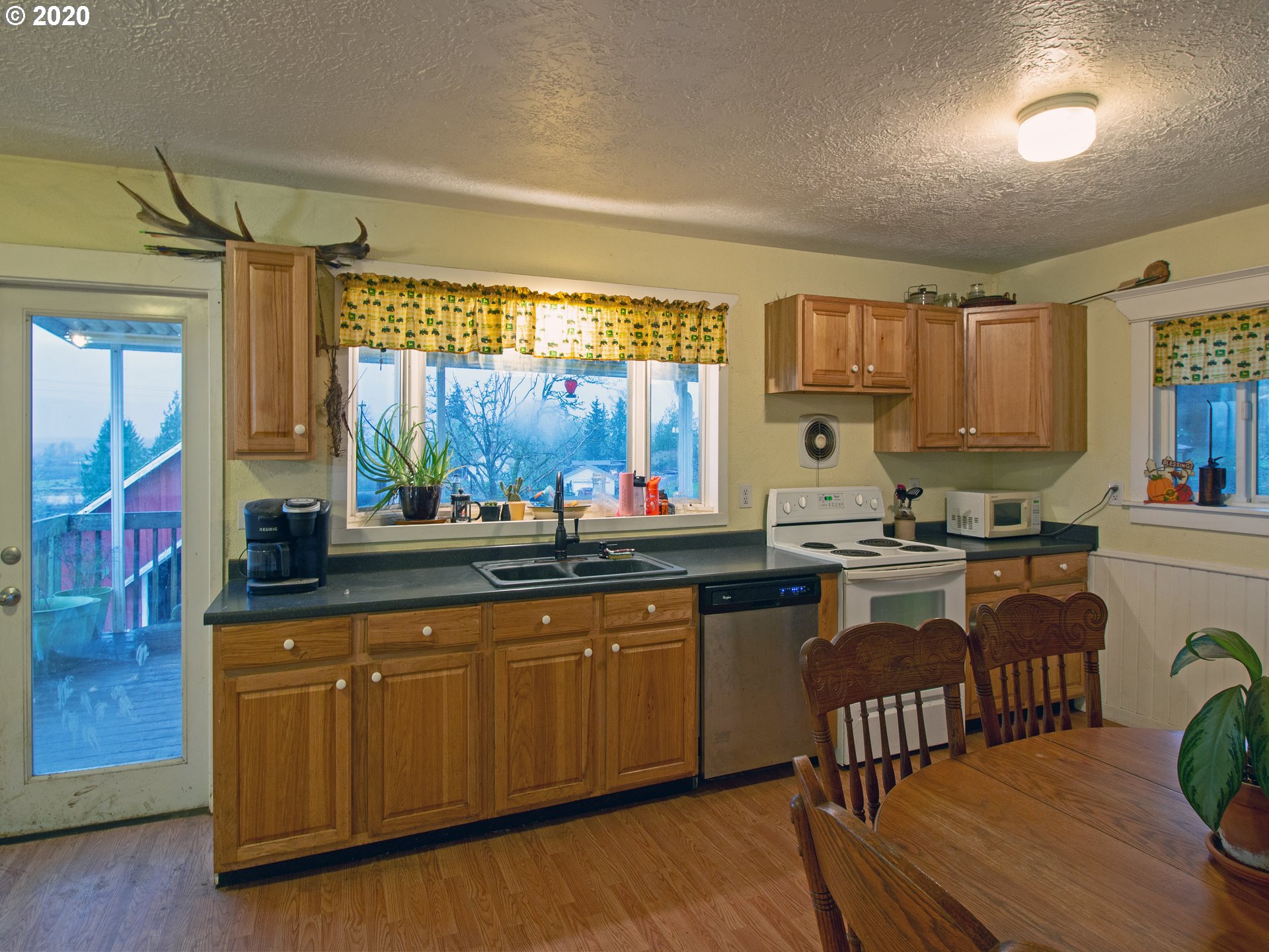18711 Beaver Falls Road Clatskanie, OR 97016 - Photo 7 of 14 a kitchen with lots of counter top space and wooden floor