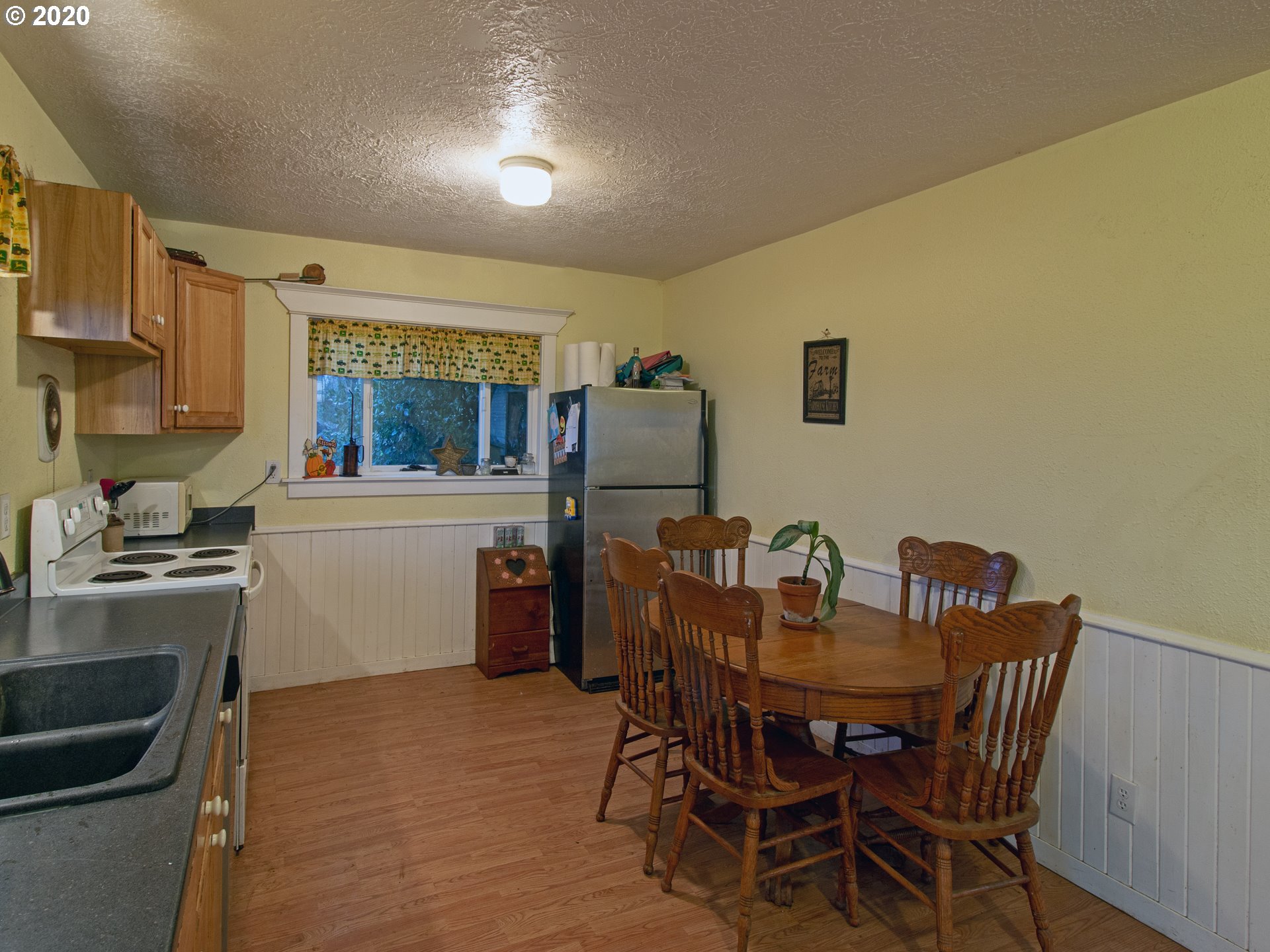 18711 Beaver Falls Road Clatskanie, OR 97016 - Photo 8 of 14 a view of a dining room with furniture and a kitchen
