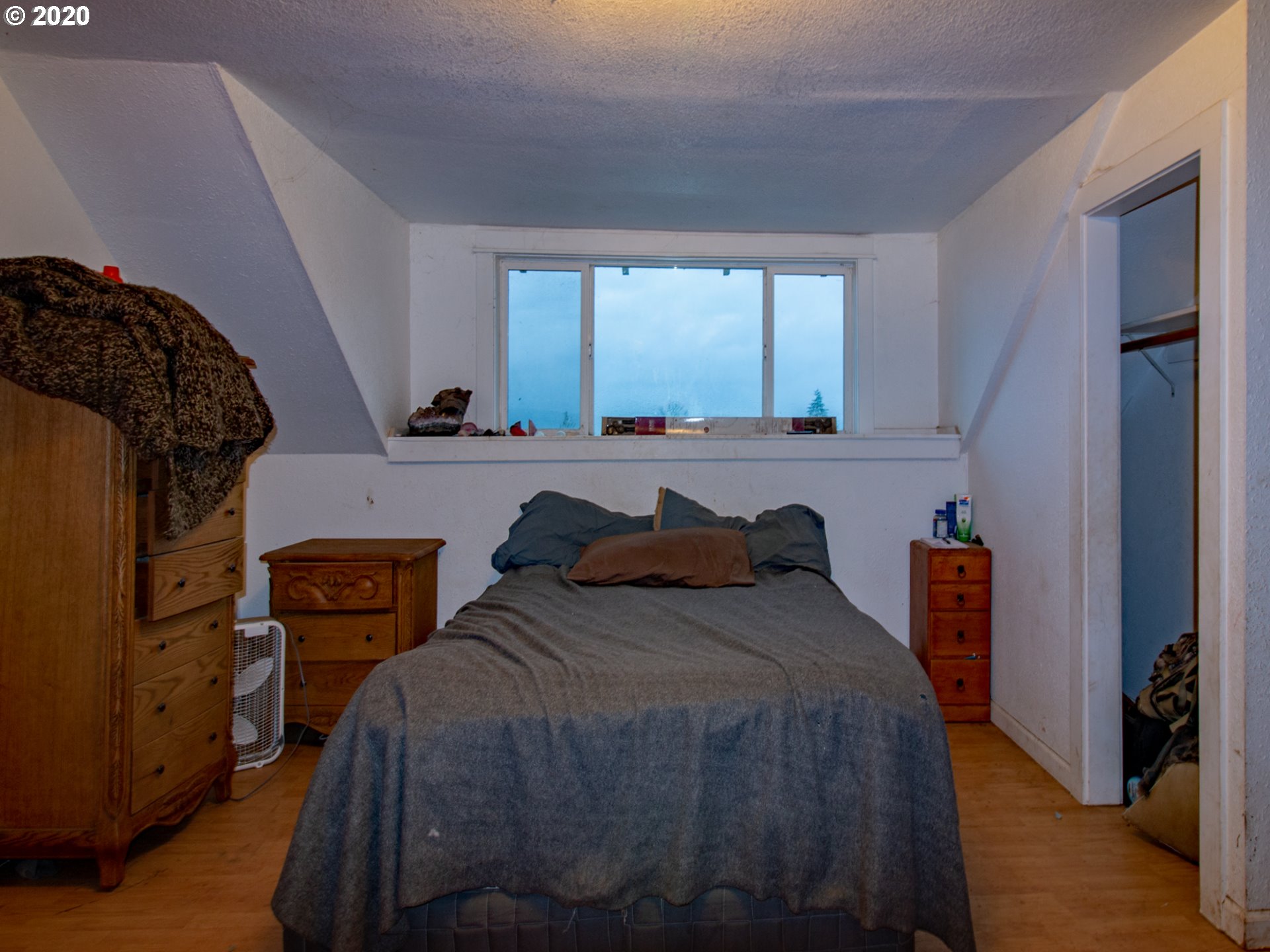18711 Beaver Falls Road Clatskanie, OR 97016 - Photo 9 of 14 a bedroom with a bed and a dresser next to a window