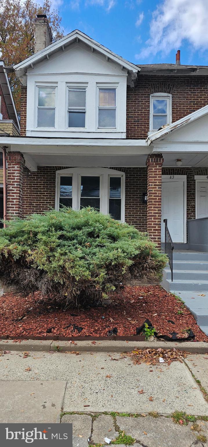 43 Laurel Avenue Trenton, NJ 08618 - Photo 1 of 1 a front view of a house with garden