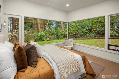 a bed sitting in a bedroom next to a large window