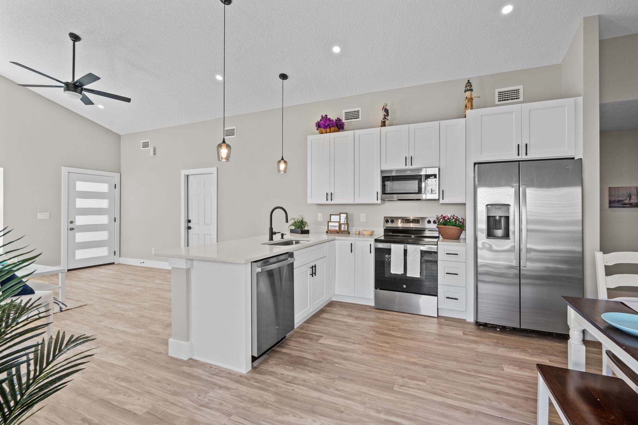 808 West 9th Street St. Augustine, FL 32084 - Photo 9 of 31 a large kitchen with cabinets stainless steel appliances and a counter space