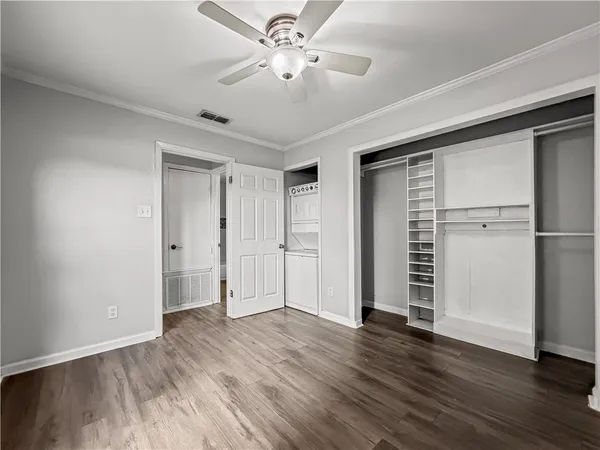 a view of empty room with wooden floor