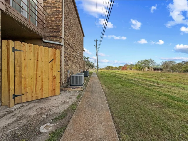 a house view with a tree in front of it