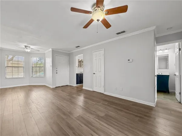 wooden floor in an empty room with a window