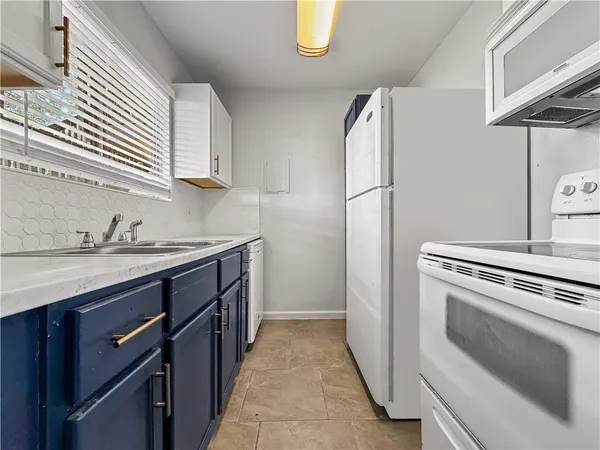 a kitchen with a stove and a sink