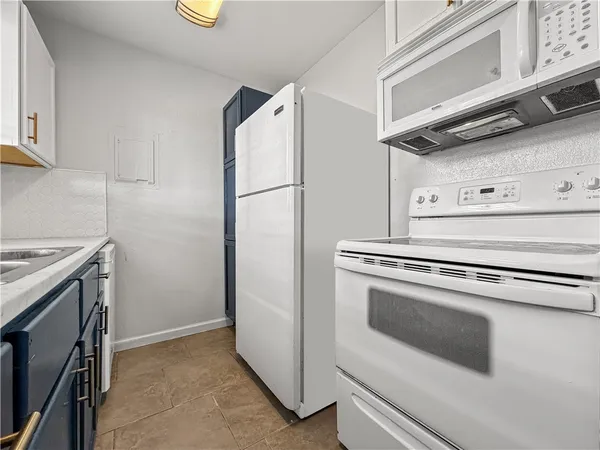 a stove top oven sitting inside of a kitchen