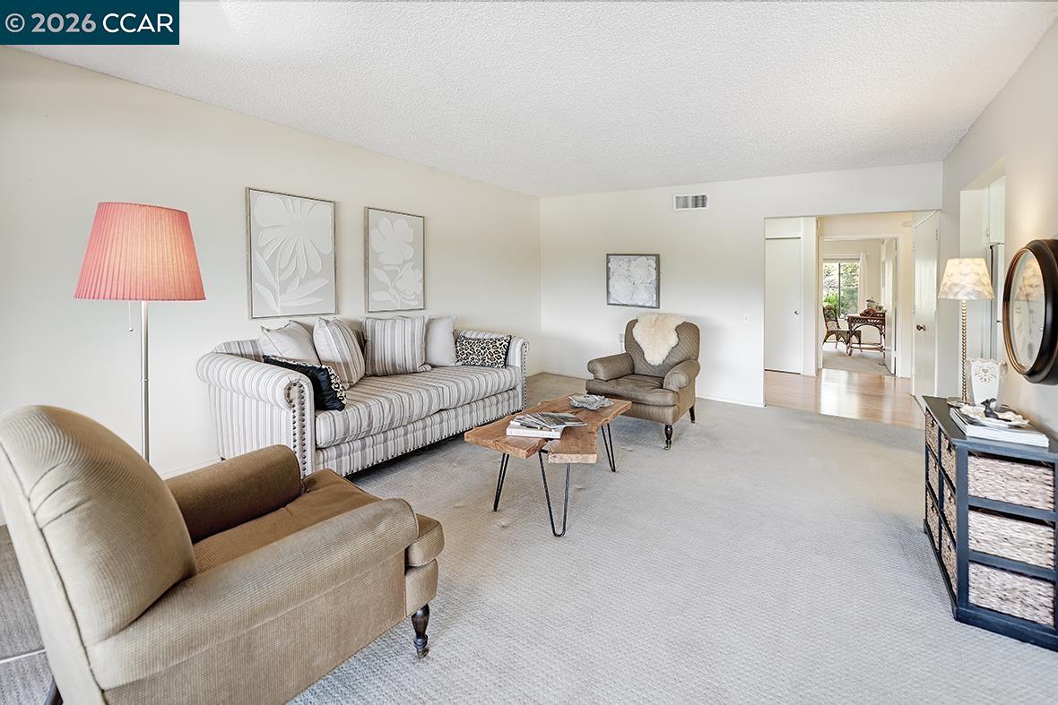 1548 Golden Rain Road, Unit 9 Walnut Creek, CA 94595 - Photo 20 of 45 a living room with furniture and a lamp