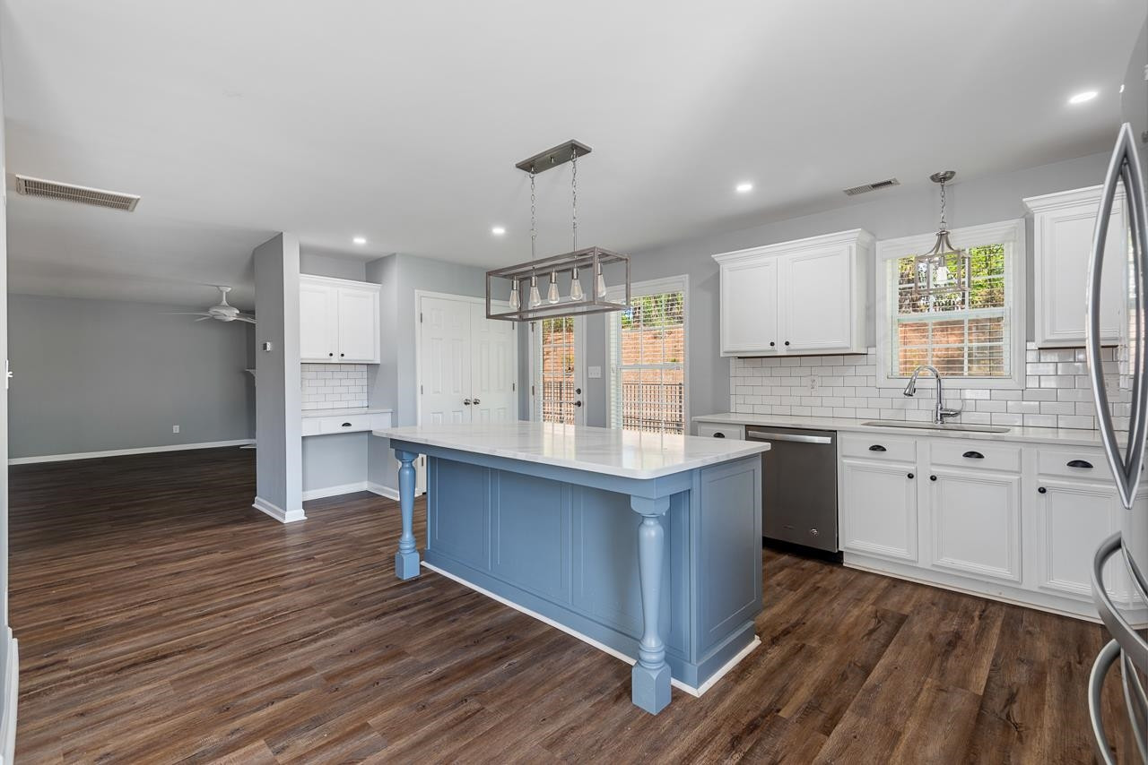 308 Saranac Ridge Drive Holly Springs, NC 27540 - Photo 12 of 41 a kitchen with stainless steel appliances granite countertop a sink stove and wooden cabinets