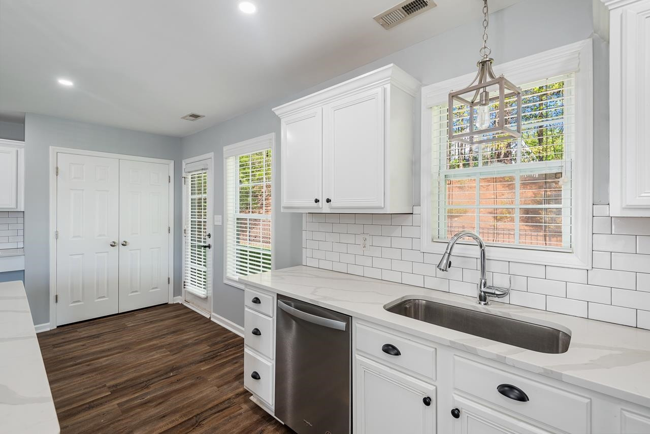 308 Saranac Ridge Drive Holly Springs, NC 27540 - Photo 15 of 41 a kitchen that has a sink and a stove in it