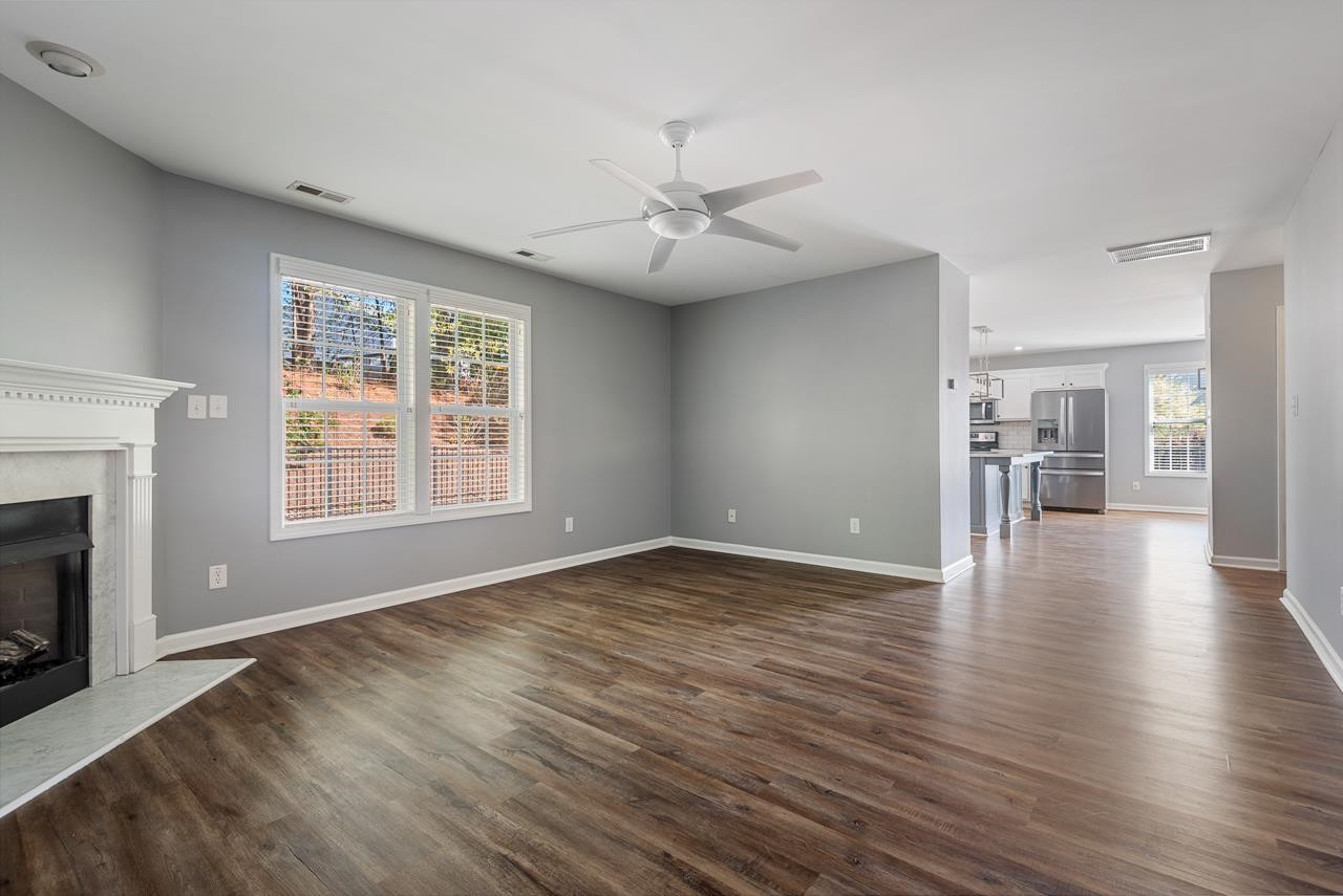 308 Saranac Ridge Drive Holly Springs, NC 27540 - Photo 20 of 41 an empty room with wooden floor fireplace and windows