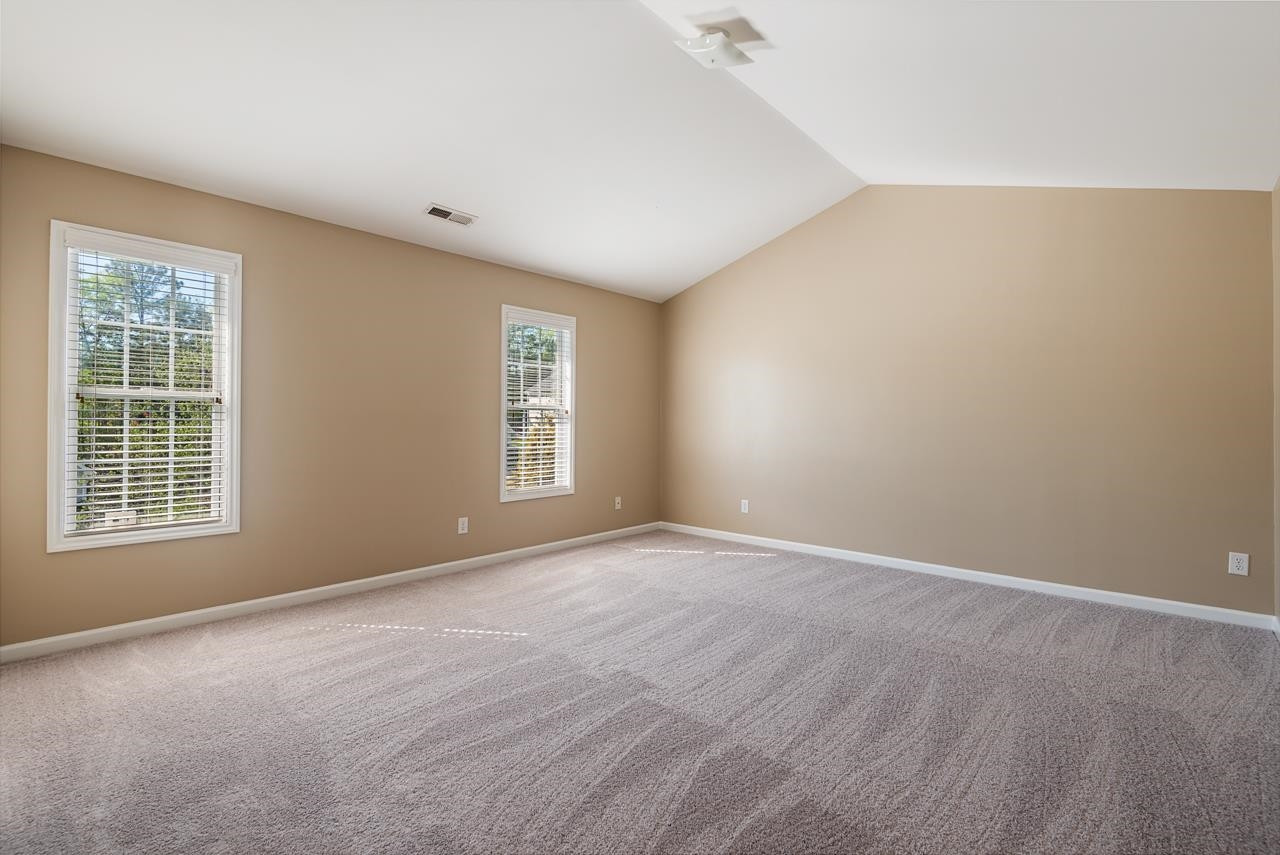 308 Saranac Ridge Drive Holly Springs, NC 27540 - Photo 22 of 41 an empty room with windows