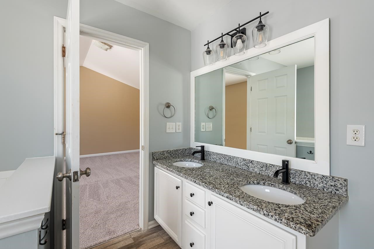 308 Saranac Ridge Drive Holly Springs, NC 27540 - Photo 24 of 41 a bathroom with a granite countertop sink and a mirror