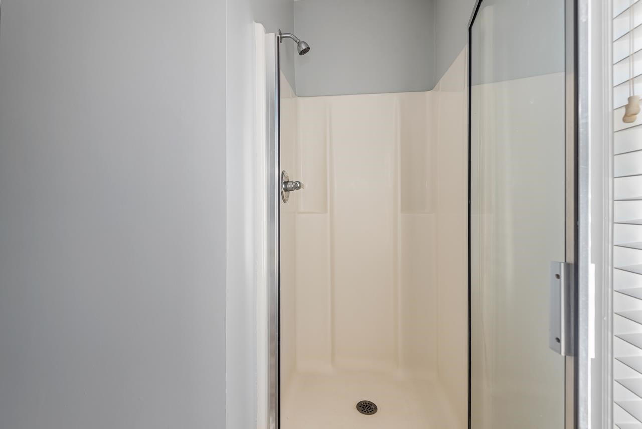 308 Saranac Ridge Drive Holly Springs, NC 27540 - Photo 26 of 41 a bathroom with a glass shower door