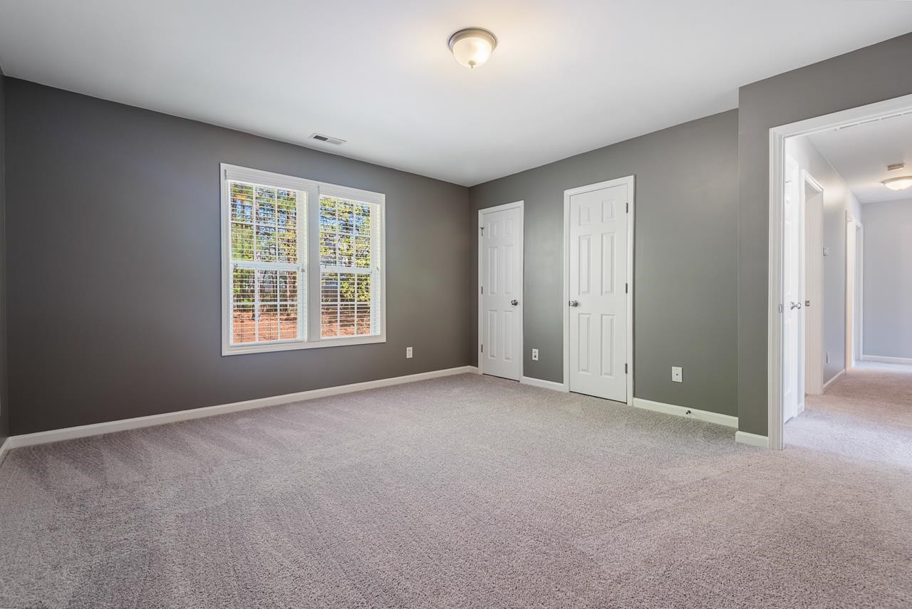 308 Saranac Ridge Drive Holly Springs, NC 27540 - Photo 28 of 41 an empty room with windows and closet