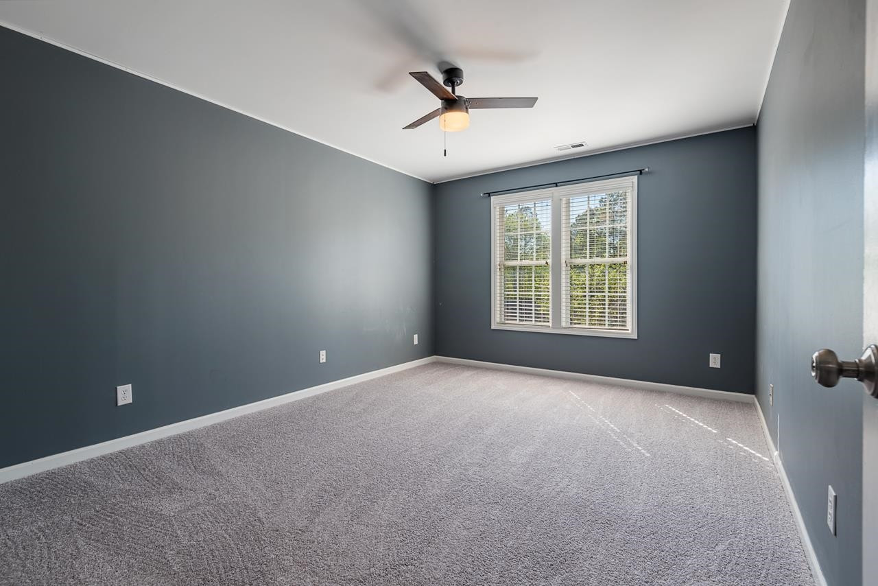 308 Saranac Ridge Drive Holly Springs, NC 27540 - Photo 30 of 41 an empty room with windows and ceiling fan