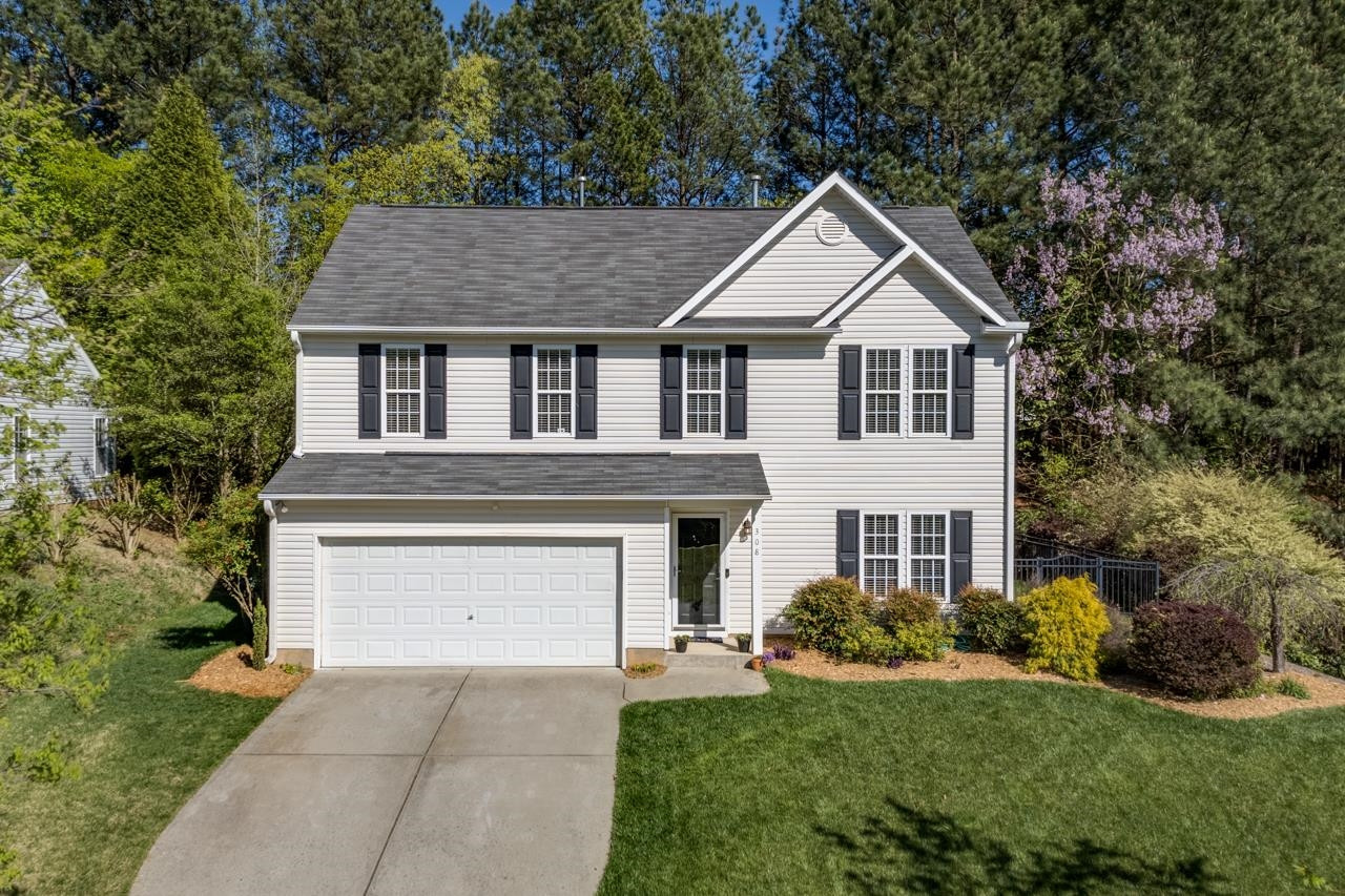 308 Saranac Ridge Drive Holly Springs, NC 27540 - Photo 3 of 41 a front view of a house with a yard and garage