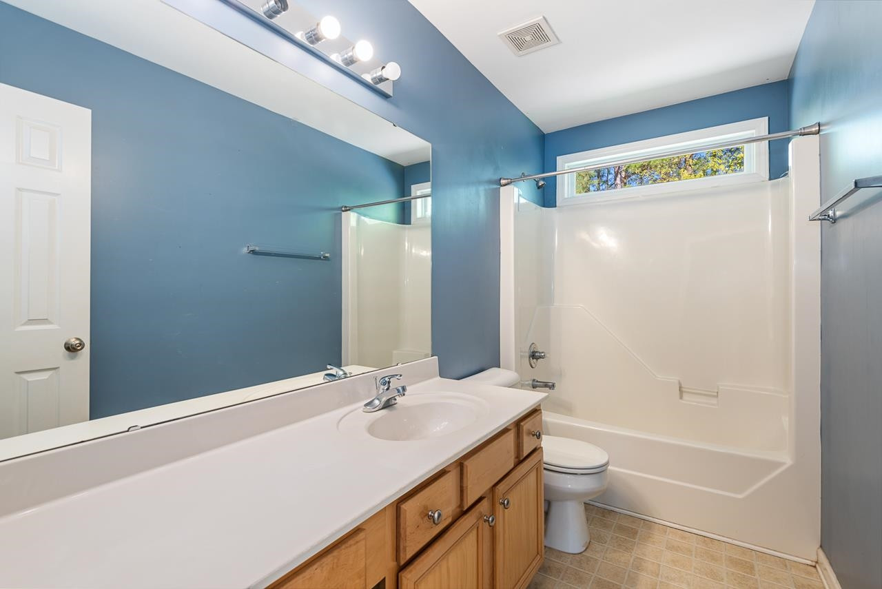 308 Saranac Ridge Drive Holly Springs, NC 27540 - Photo 32 of 41 a bathroom with a granite countertop sink toilet and shower