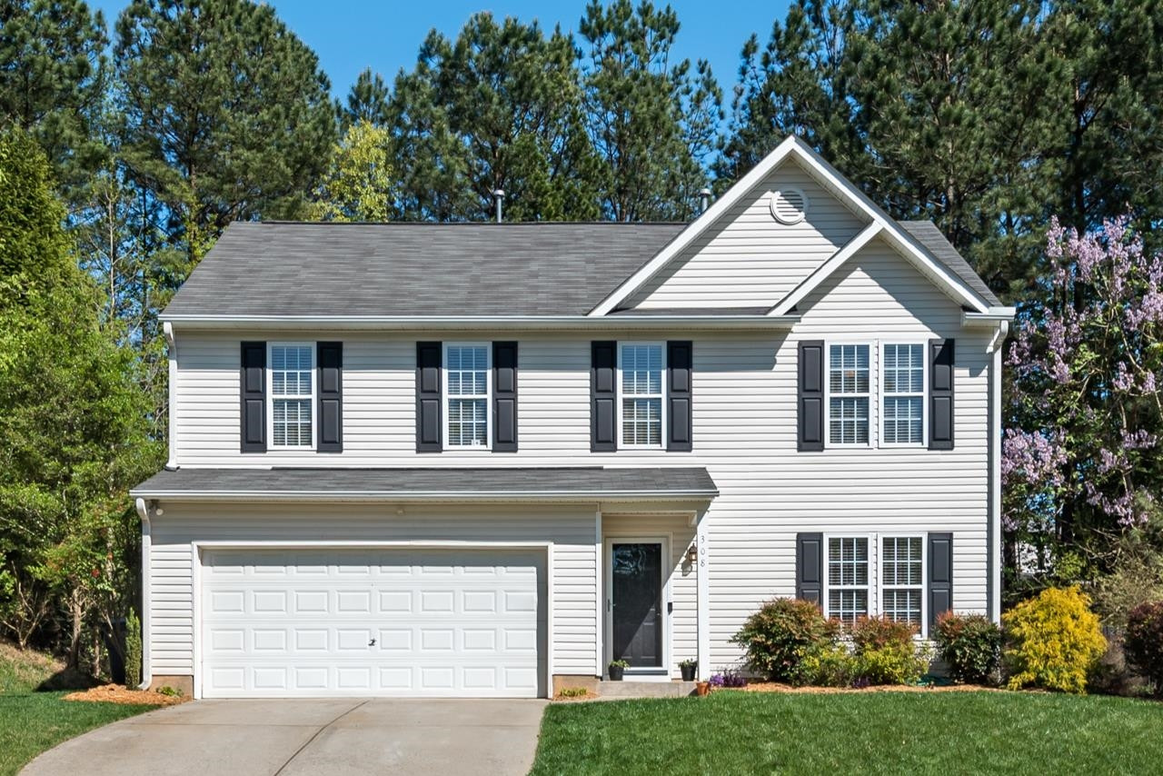 308 Saranac Ridge Drive Holly Springs, NC 27540 - Photo 4 of 41 a front view of a house with garden