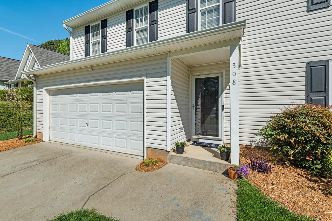 308 Saranac Ridge Drive Holly Springs, NC 27540 - Photo 5 of 41 a front view of a house with garage