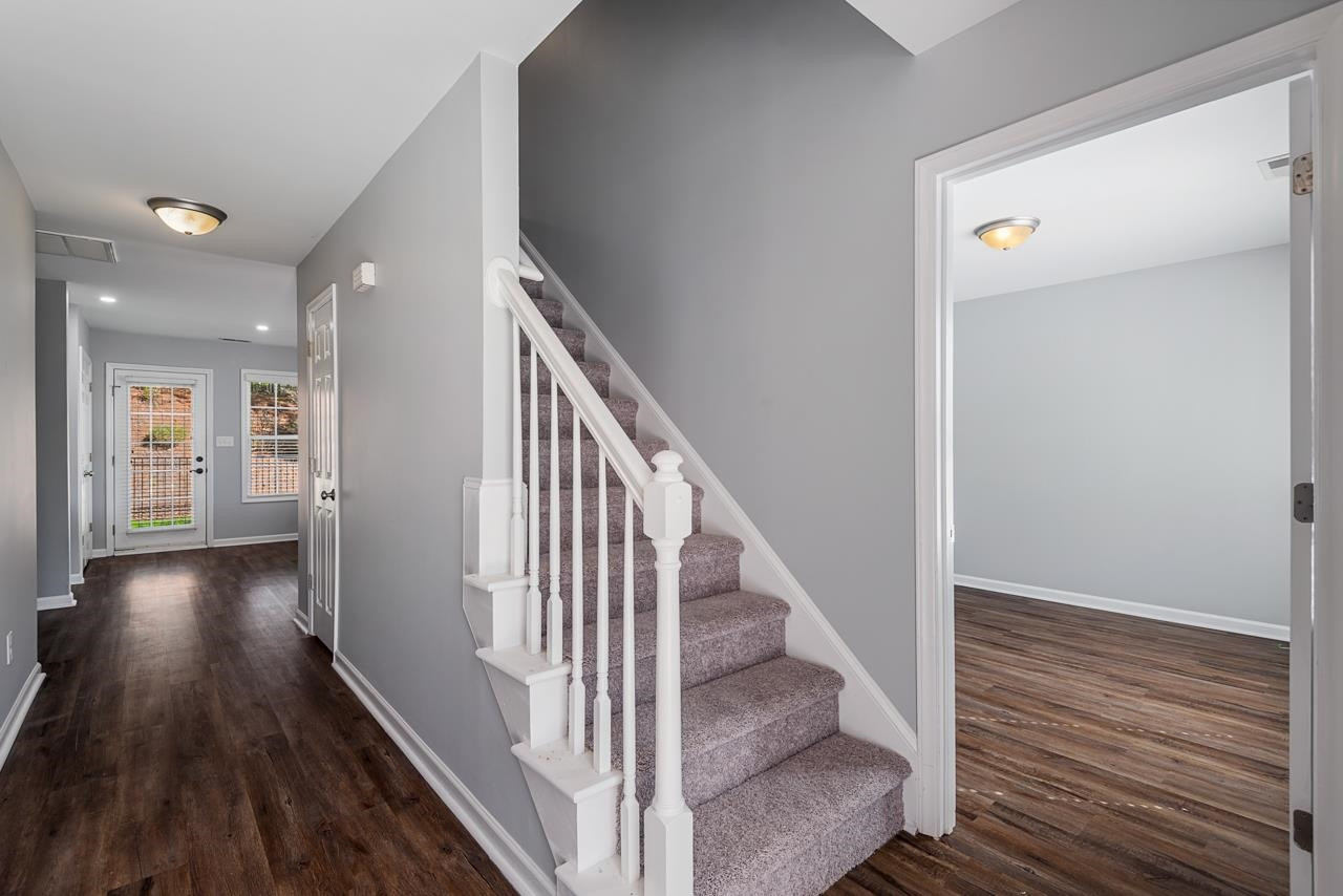 308 Saranac Ridge Drive Holly Springs, NC 27540 - Photo 6 of 41 a view of a hallway with wooden floor and staircase