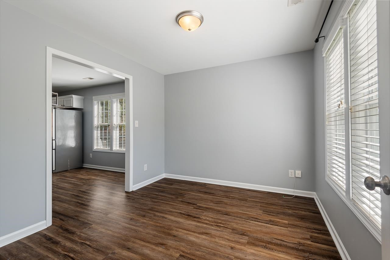 308 Saranac Ridge Drive Holly Springs, NC 27540 - Photo 7 of 41 a view of an empty room with wooden floor and a window