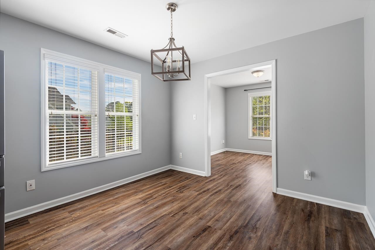 308 Saranac Ridge Drive Holly Springs, NC 27540 - Photo 10 of 41 a view of empty room with wooden floor and window