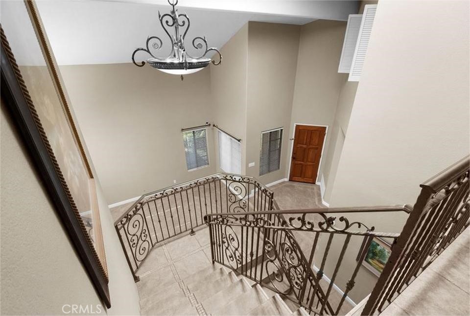 42050 Humber Drive Temecula, CA 92591 - Photo 11 of 31 a view of staircase with railing and white walls