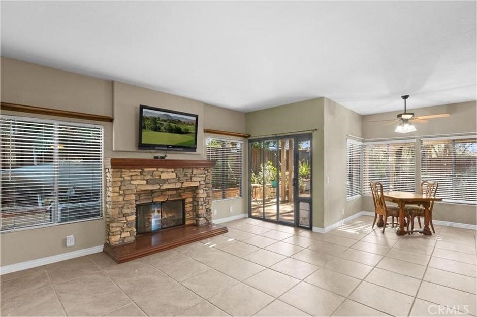42050 Humber Drive Temecula, CA 92591 - Photo 14 of 31 a living room with furniture a fireplace and a flat screen tv
