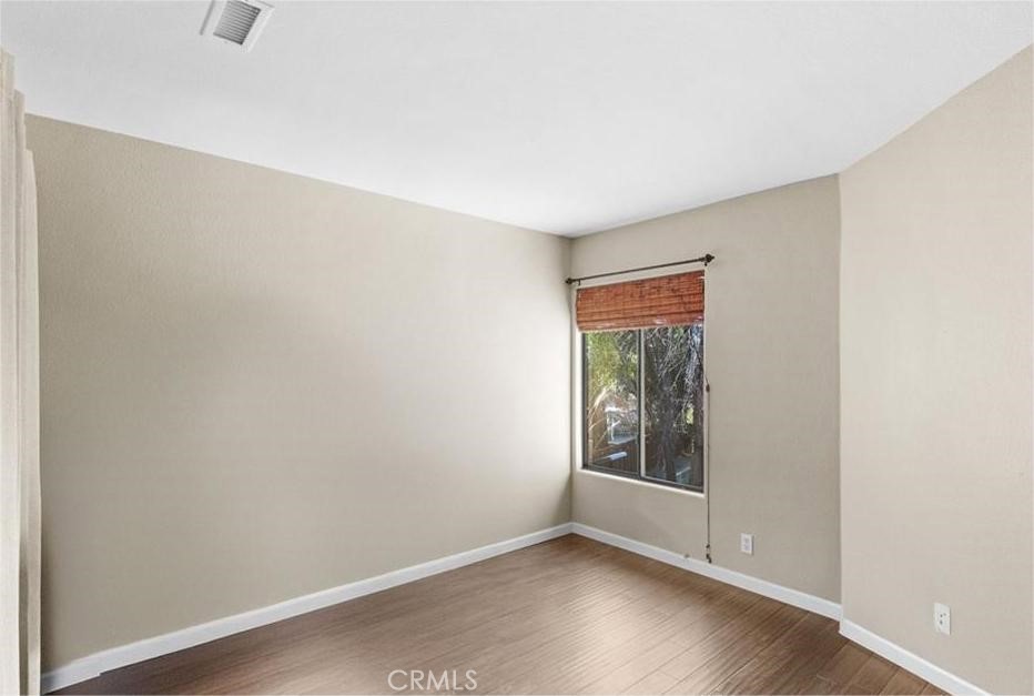 42050 Humber Drive Temecula, CA 92591 - Photo 18 of 31 a view of an empty room with wooden floor and a window