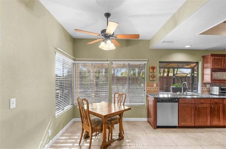 42050 Humber Drive Temecula, CA 92591 - Photo 24 of 31 a dining room with chandelier fan and a rug