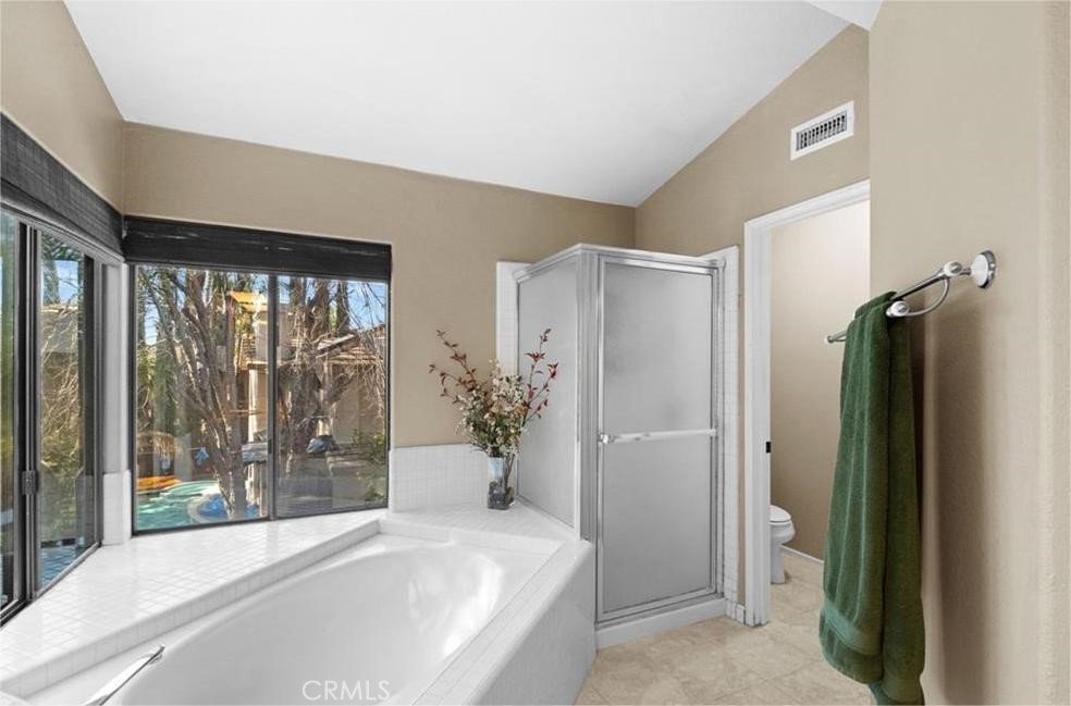 42050 Humber Drive Temecula, CA 92591 - Photo 28 of 31 a bathroom with a bathtub and a shower