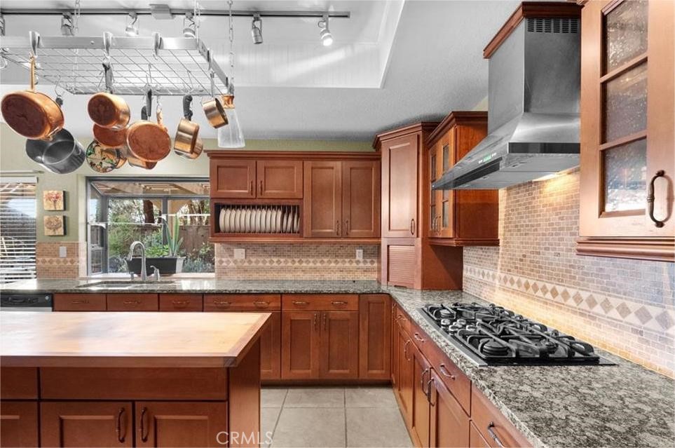 42050 Humber Drive Temecula, CA 92591 - Photo 10 of 31 a kitchen with stainless steel appliances granite countertop a stove a sink and a microwave